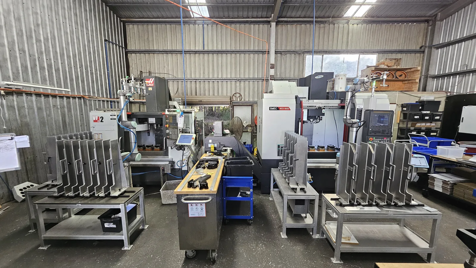 Collaborative robot tending CNC machines in a Victorian workshop