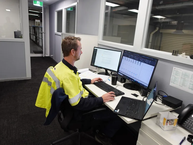 Engineer working on CAD drawings at a dual-monitor workstation