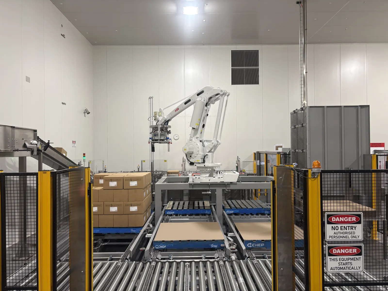 Guarded industrial robot cell with safety devices installed
