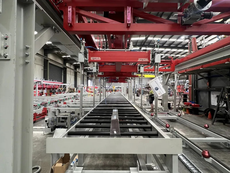 Overhead gantry conveyor system in a manufacturing facility
