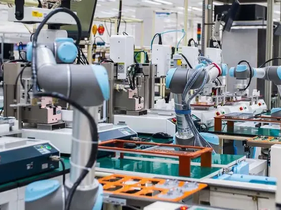 Universal Robots cobots working at a production bench